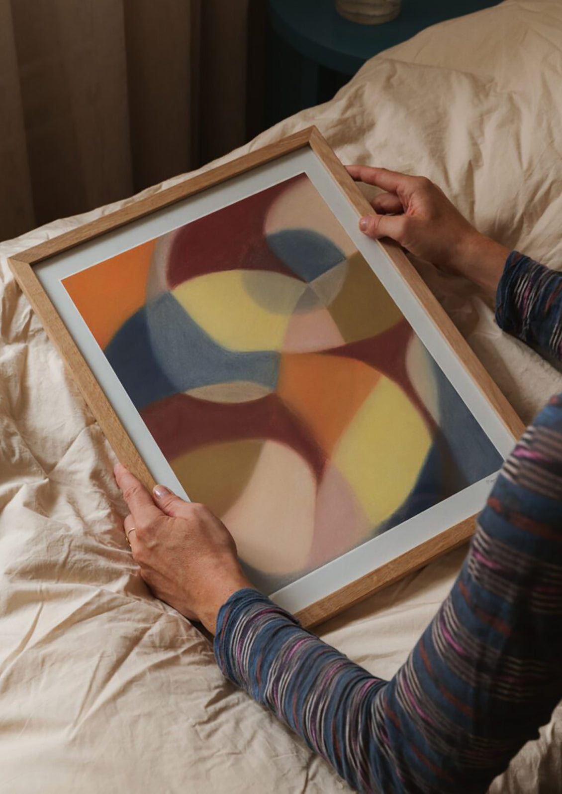 An abstract art print of swirling geometric shapes in a muted color palette.