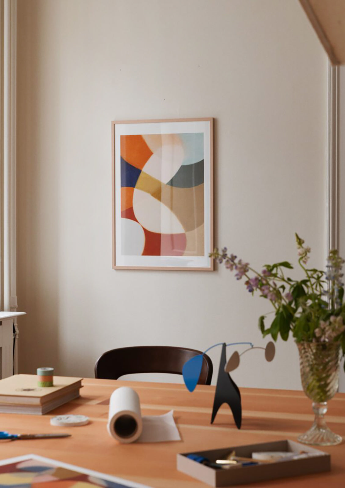 An abstract art print with swirling geometric shapes in bright colors.