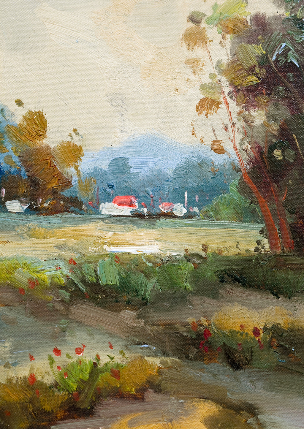 2: A framed landscape oil painting of trees and houses near a creek.