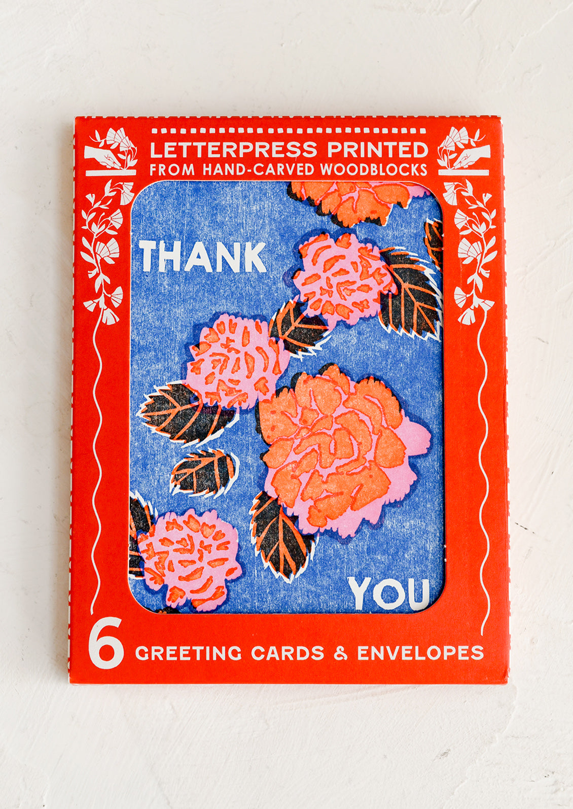 Blue thank you cards with red floral pattern.
