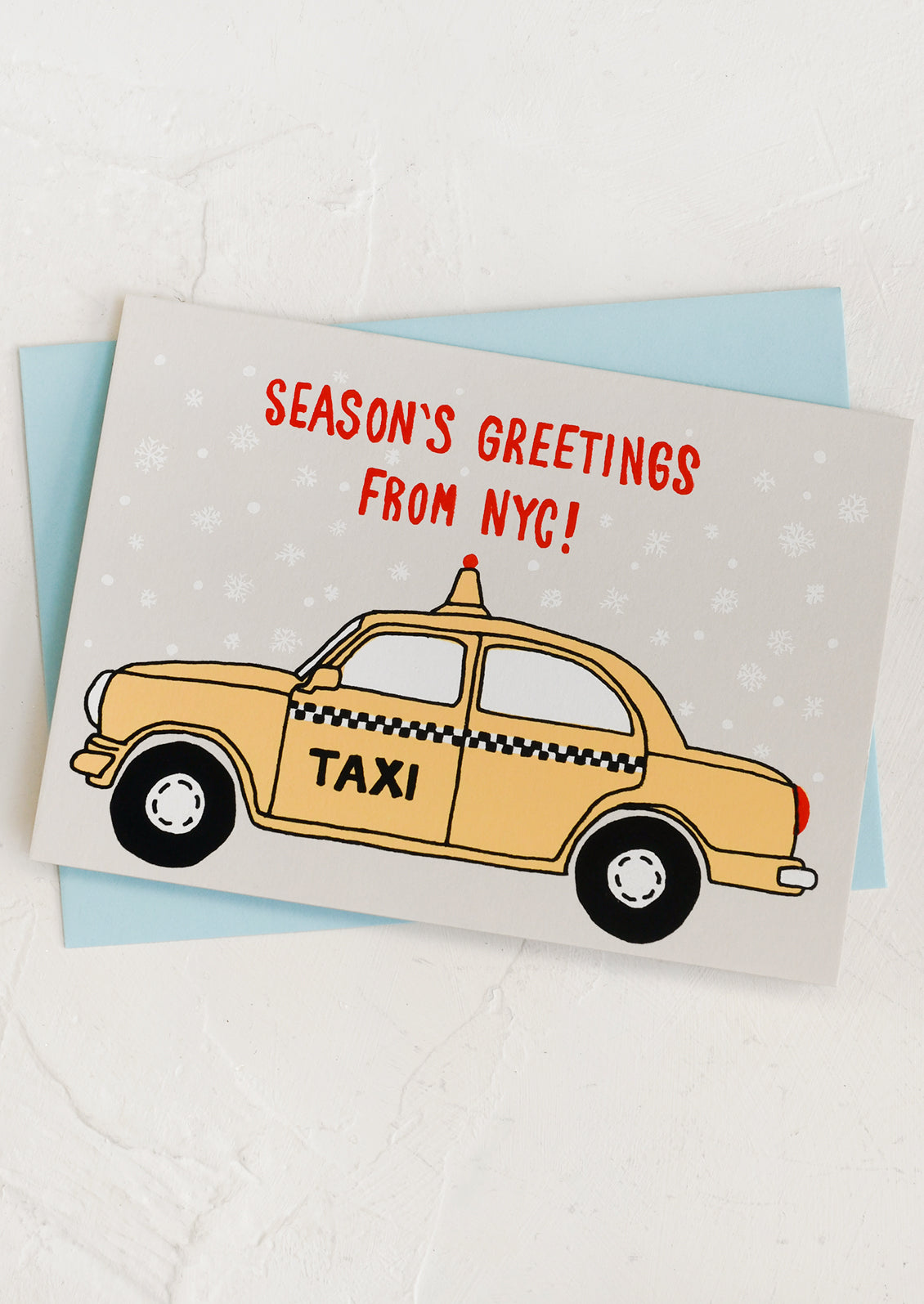 A set of cards with screen printed taxi design, text reads "Season's Greetings from NYC!".