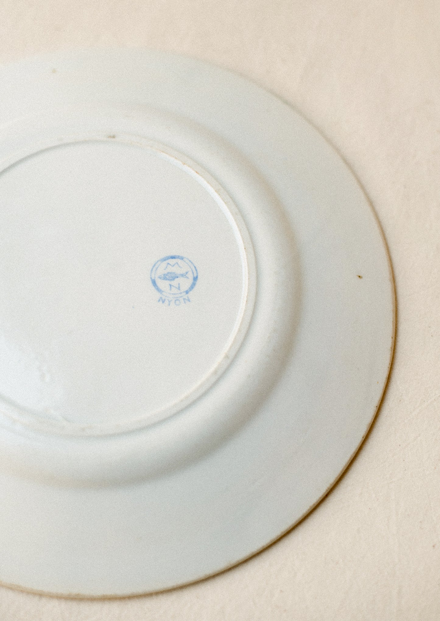 Blue fish maker's mark on back of plate.