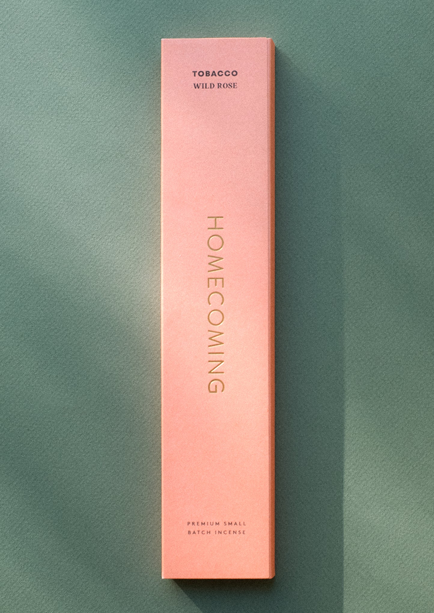 A box of incense in coral color, tobacco rose scent.