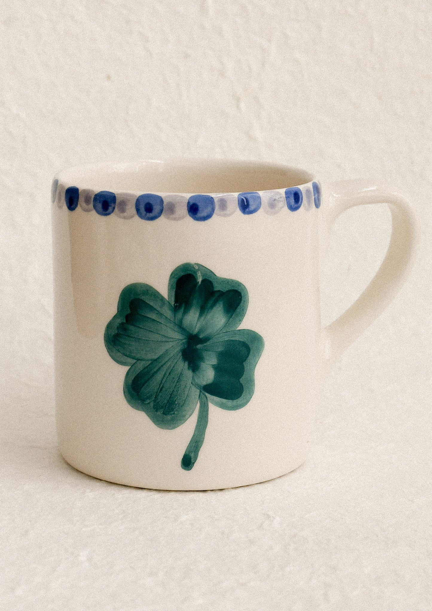 A hand painted mug with clover motif.
