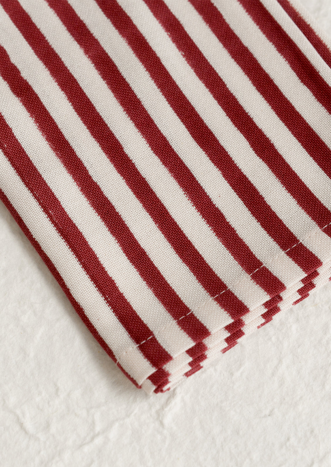 A pair of cotton napkins in vertical red and cream stripe.