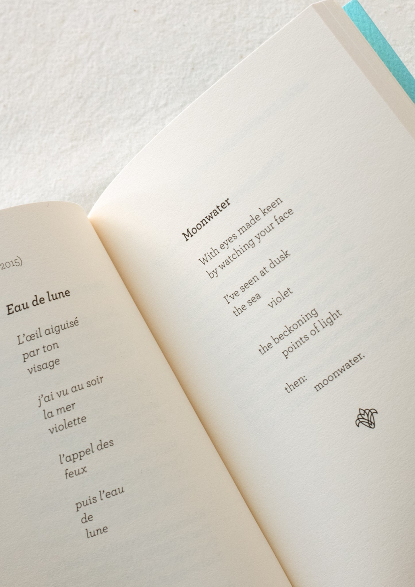 Small blue book with red writing featuring the text "french love poems".