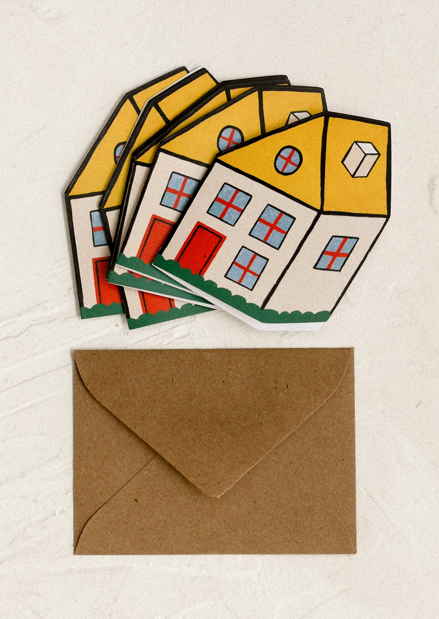 Set of house-shaped cards with a brown envelope.