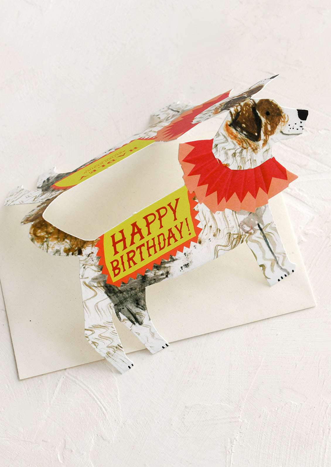 A diecut greeting card in the shape of a dog, text reads "Happy Birthday!".