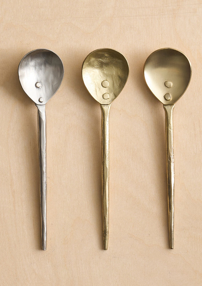 1: Small spoons in silver and gold tone metal.