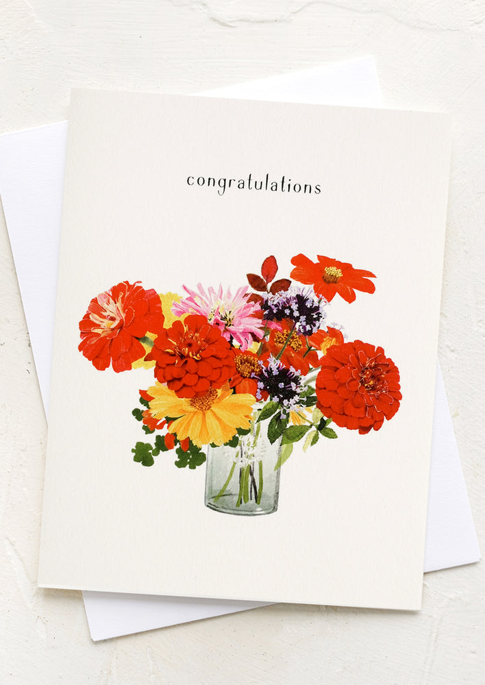 A card with image of zinnia bouquet, text above reads "Congratulations".