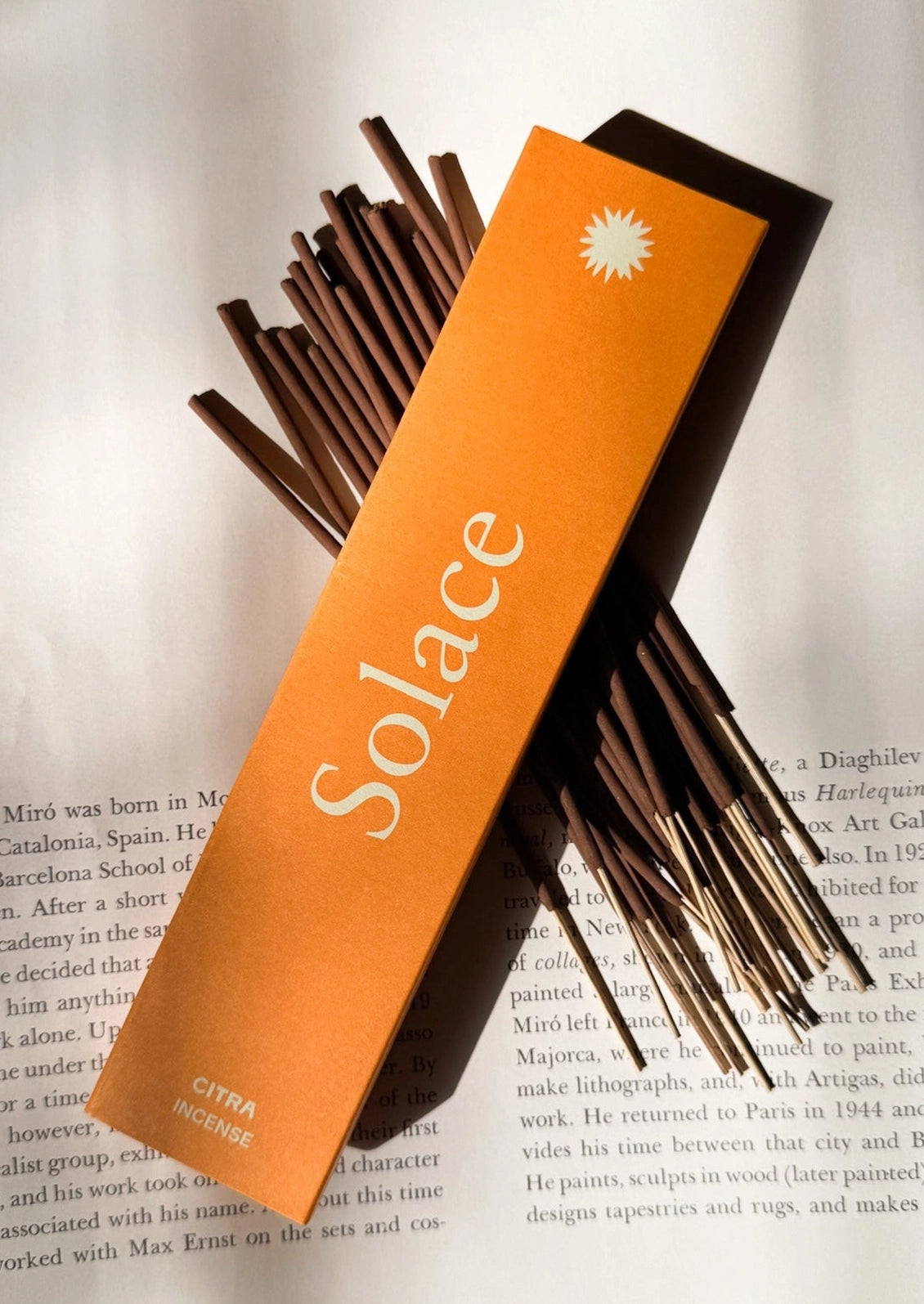 A pack of incense in "Solace" scent, box is orange.