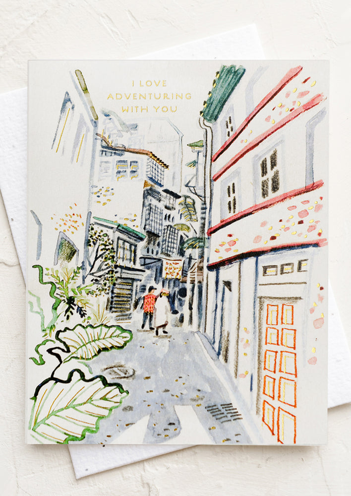 A card with illustration of people wandering in a European alleyway, text reads "I love adventuring with you".