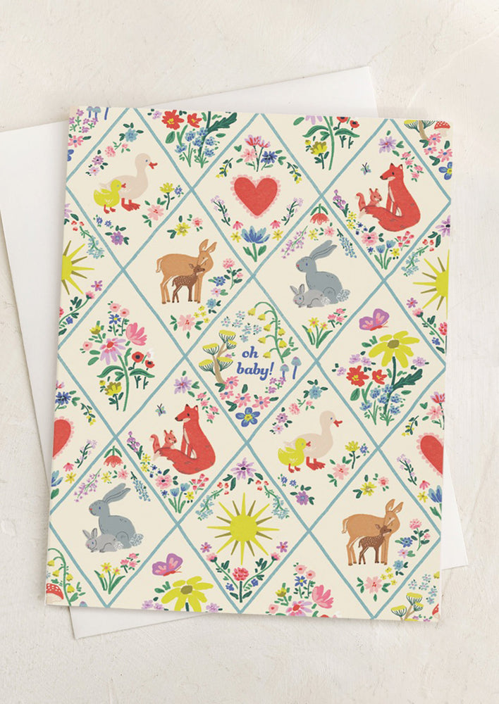 A card with illustration of animals in quilt-like pattern, text reads "Oh baby!".