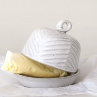 1: A ceramic butter dome in round shape with texture.