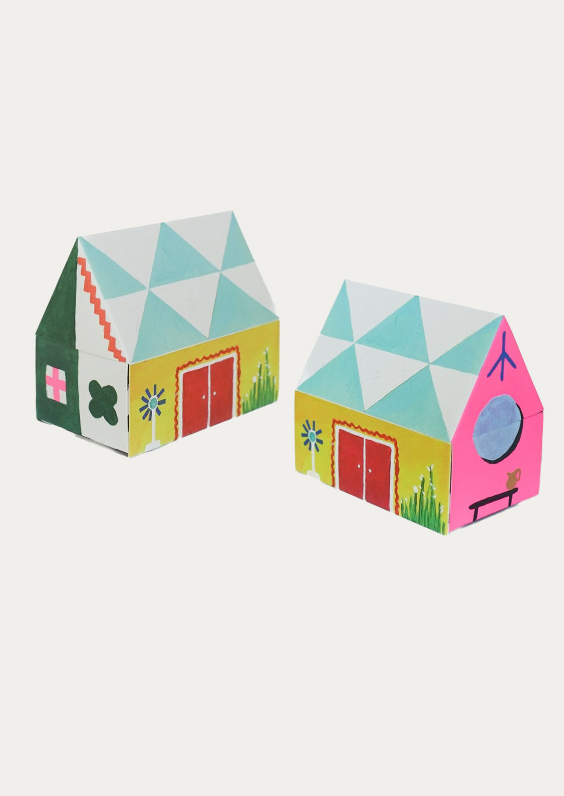 Two colorful geometric house-shaped boxes on a white background