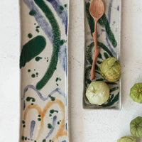 1: Long rectangular ceramic trays with multicolor paint splatter pattern.