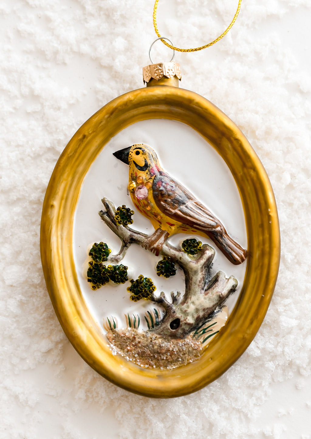 Yellow Bird: A glass ornament of gold frame around yellow bird.