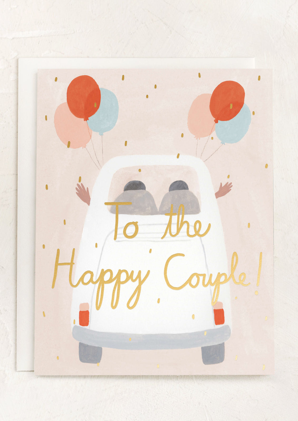 A card with illustration of couple driving away in a car with balloons, text reads "To the happy couple!".