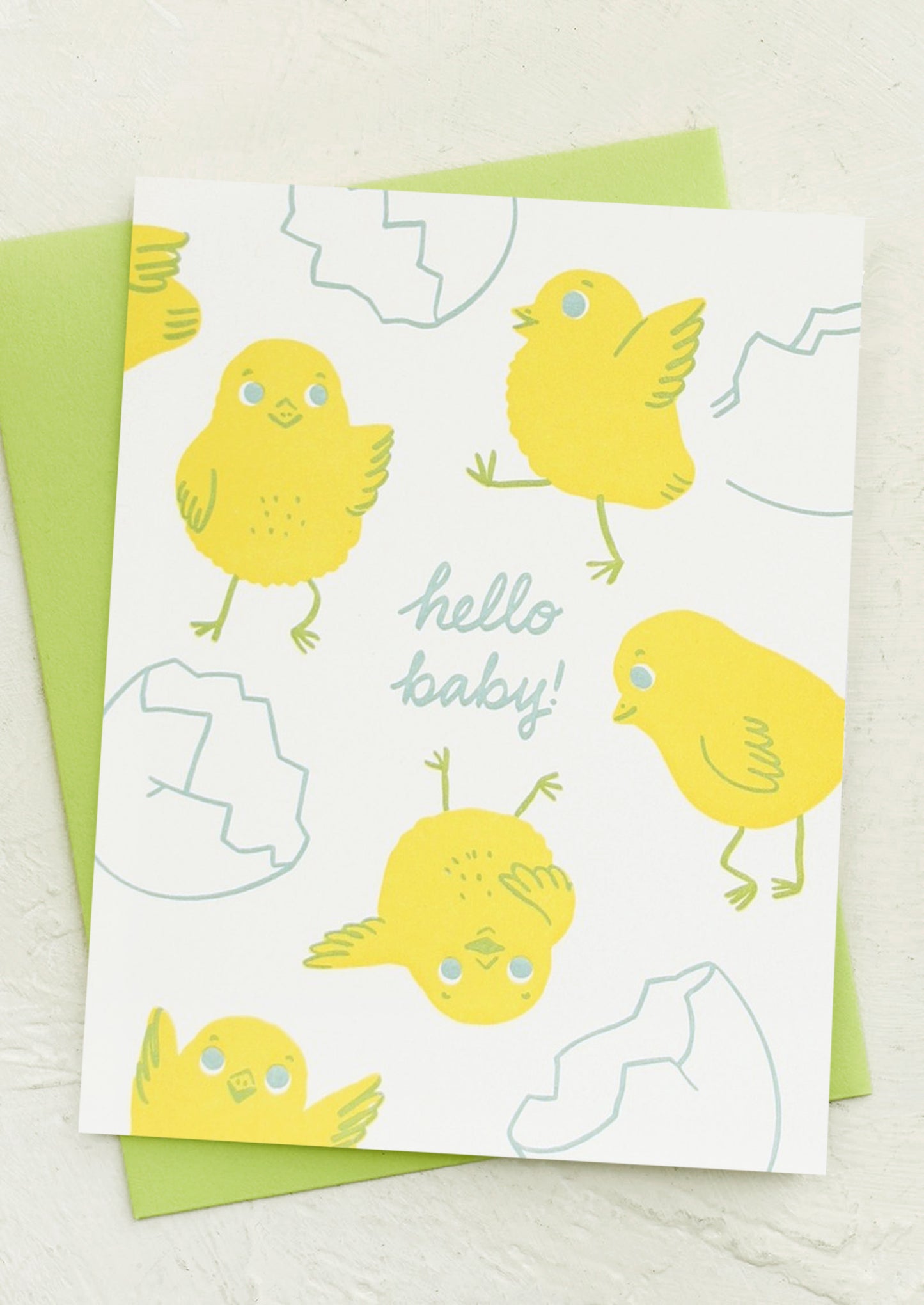 A greeting card with illustration of hatching baby chicks, text reads "Hello Baby!".