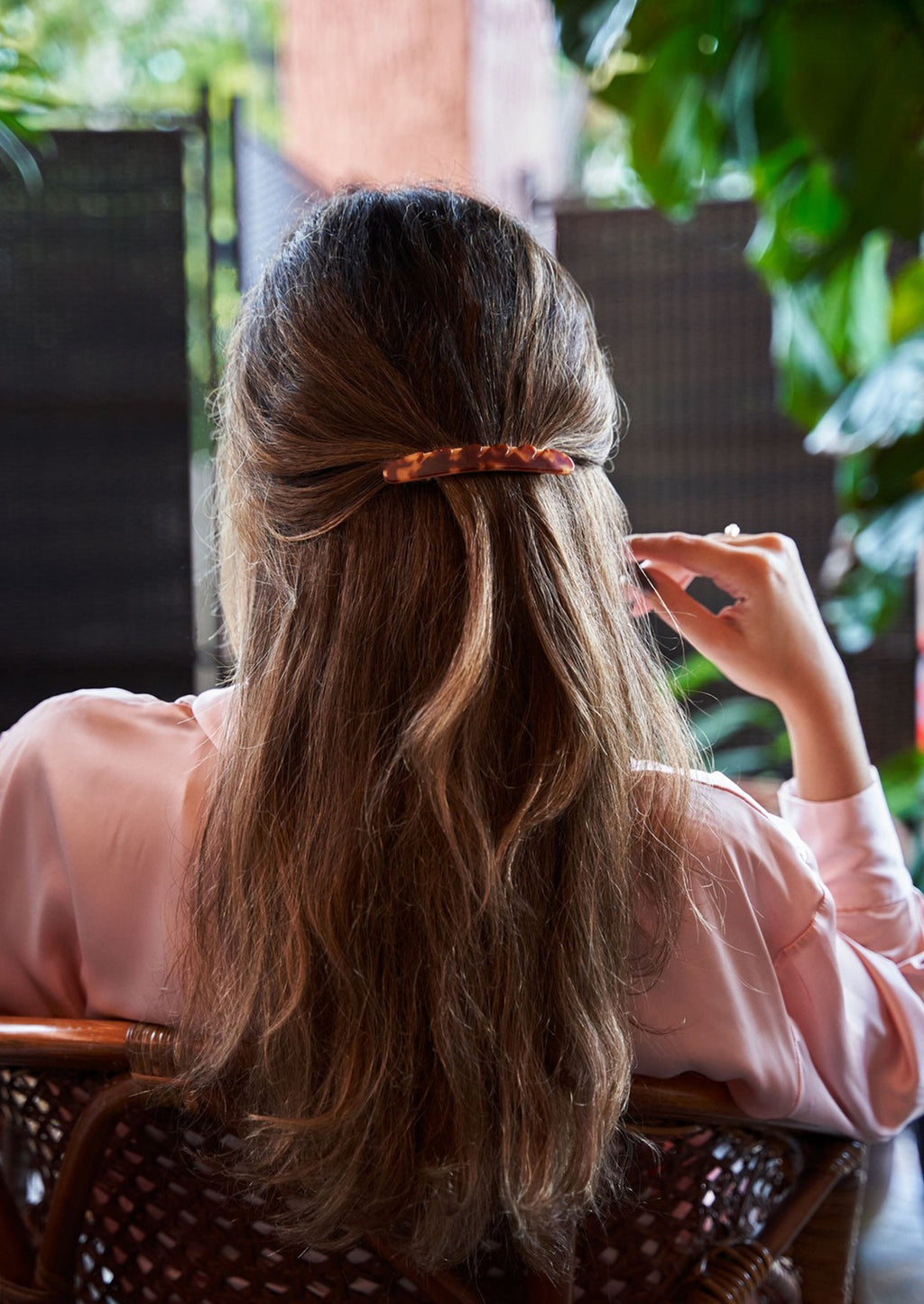 4: A woman wearing a baguette hair clip.