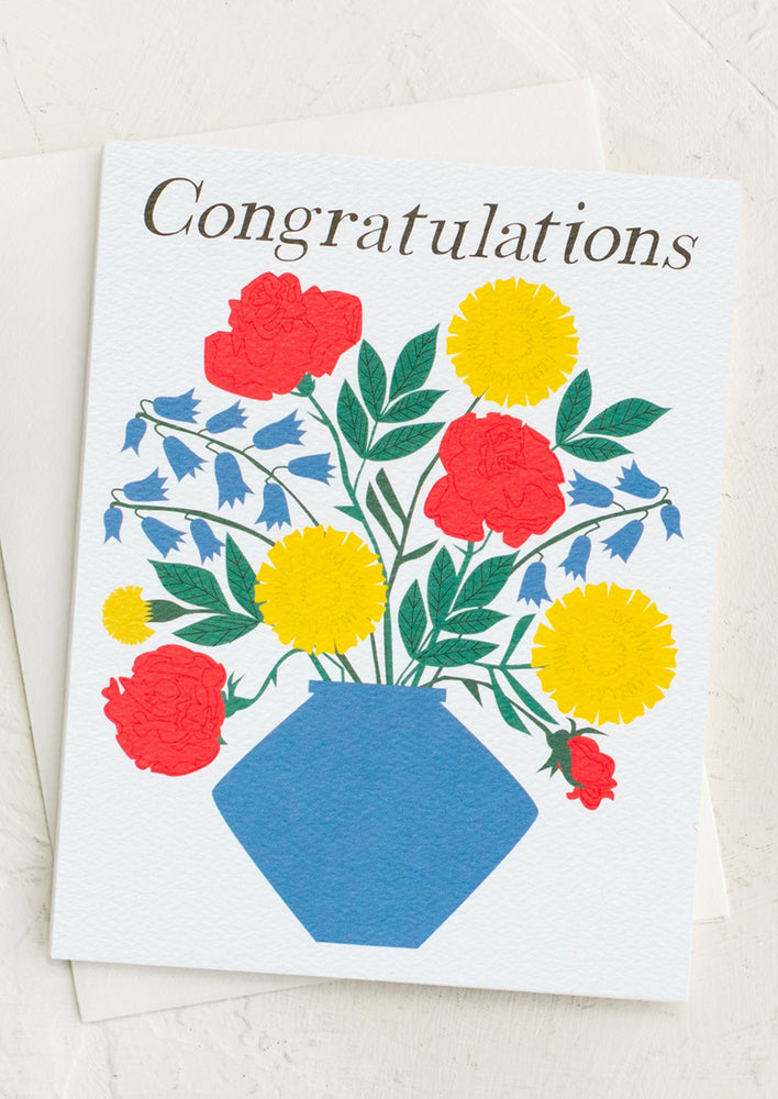 A card with primary color vase of flowers, text reads "Congratulations".