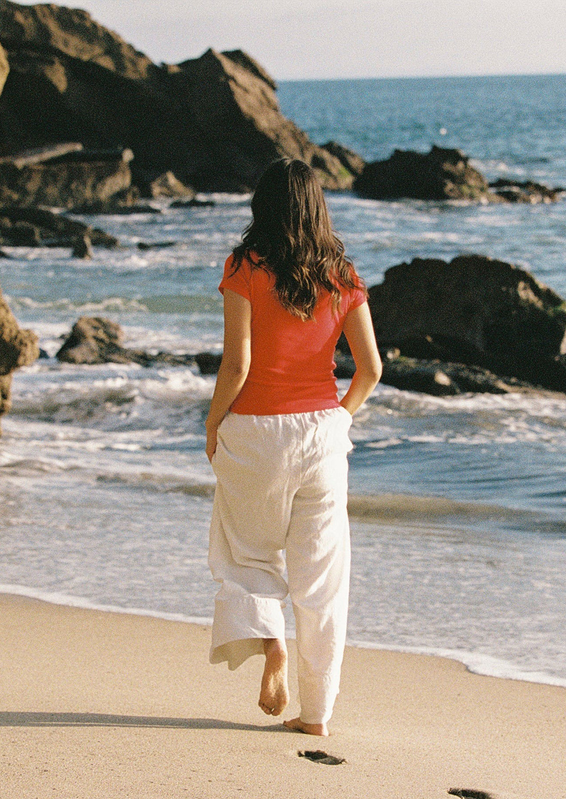 A woman wearing a red short sleeve tee.