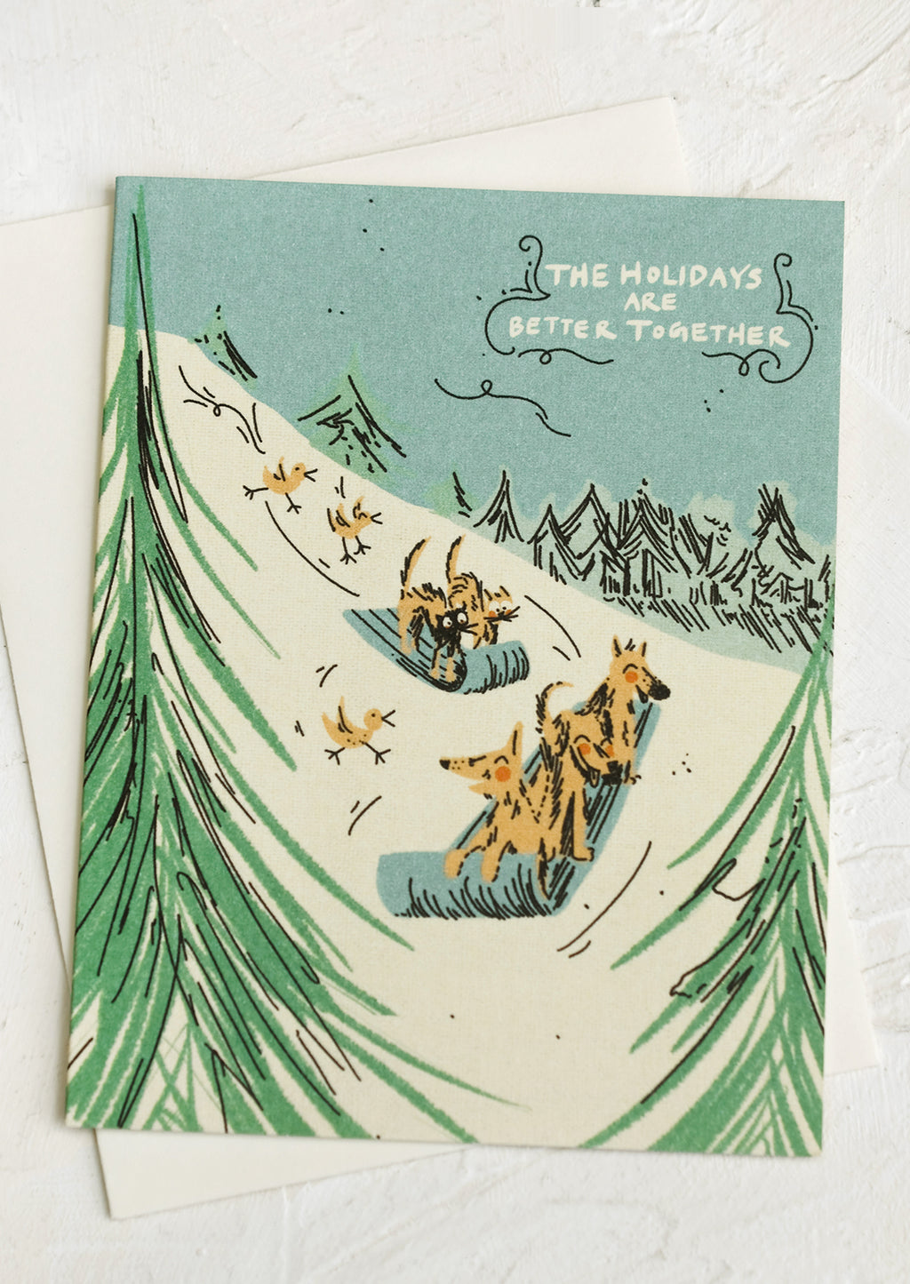 2: Greeting cards with illustration of dogs sledding down a hill, text reads "The Holidays Are Better Together".