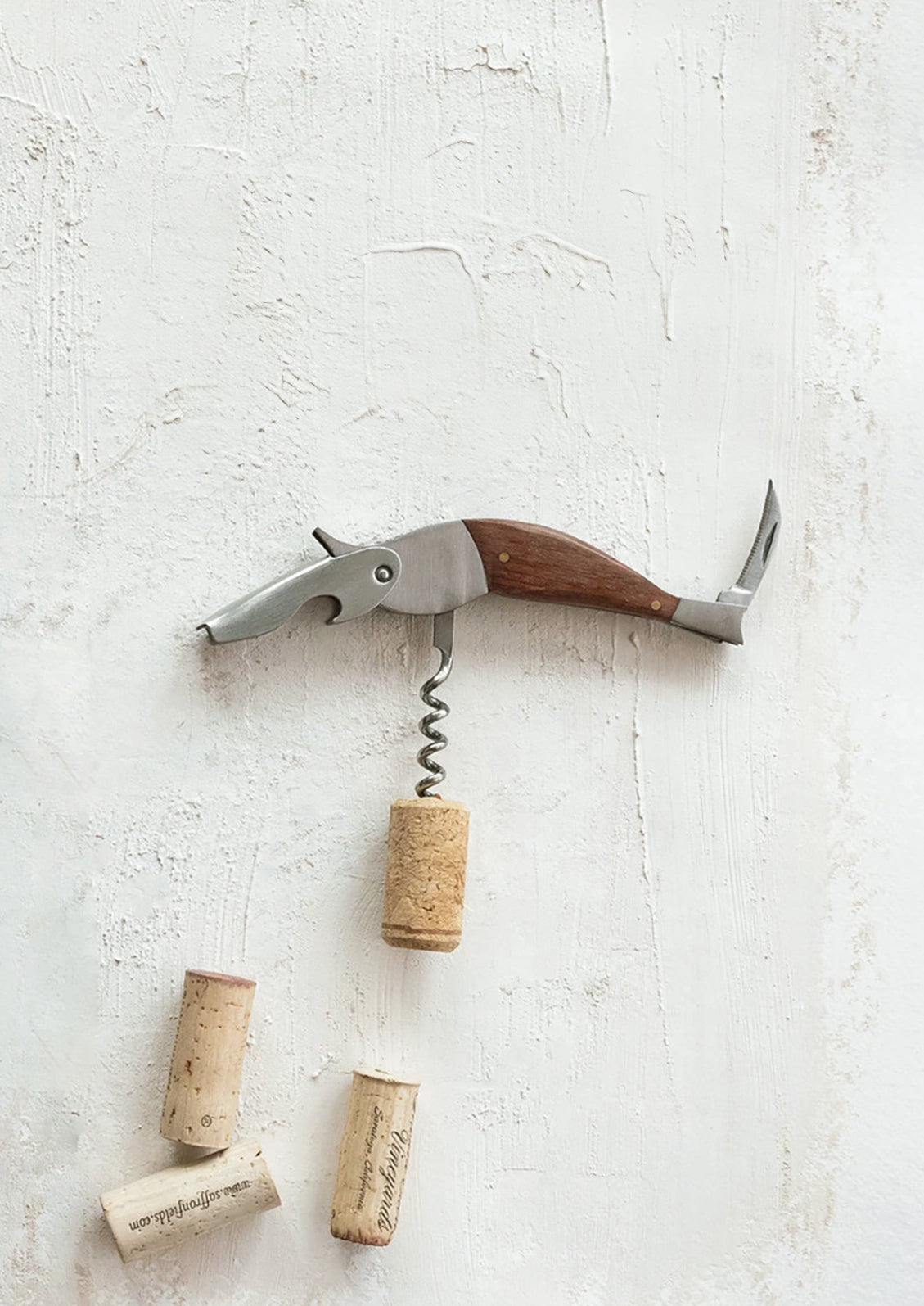 A metal and wood corkscrew resembling a bird.