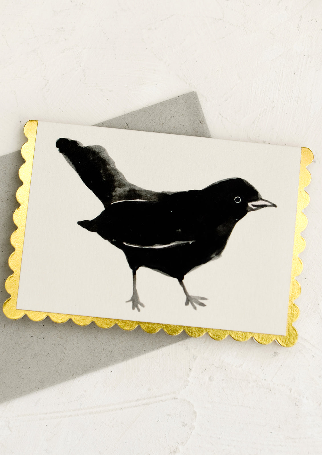 A scalloped edge greeting card with blackbird.