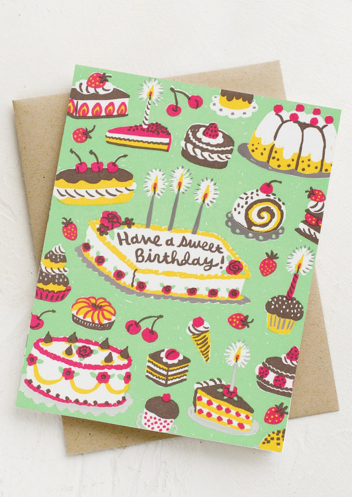 1: A green card with image of a bunch of different desserts, text reads "Have a sweet birthday!".