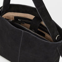 4: A suede handbag in black.