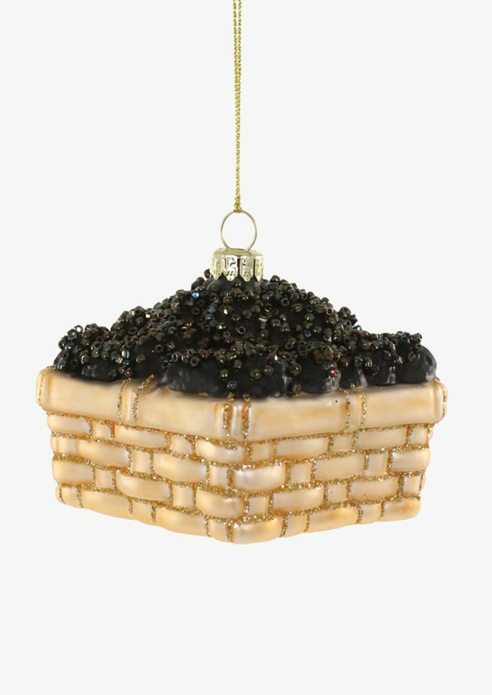 1: A glass ornament of a golden basket holding blackberries.