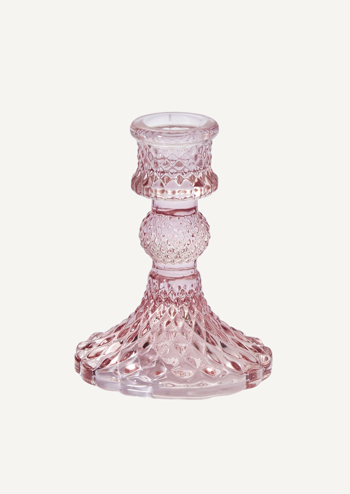 A glass candlestick holder in facet textured glass, pink color.