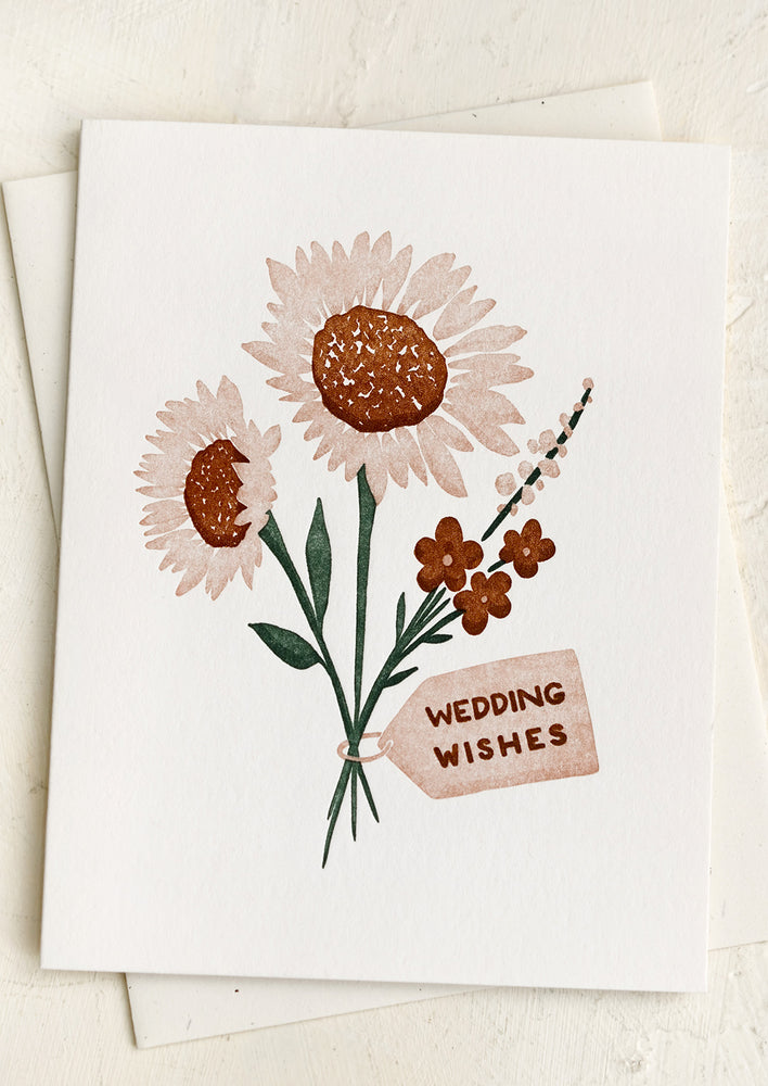 1: A greeting card with letterpressed image of flower, text reads "Wedding wishes".