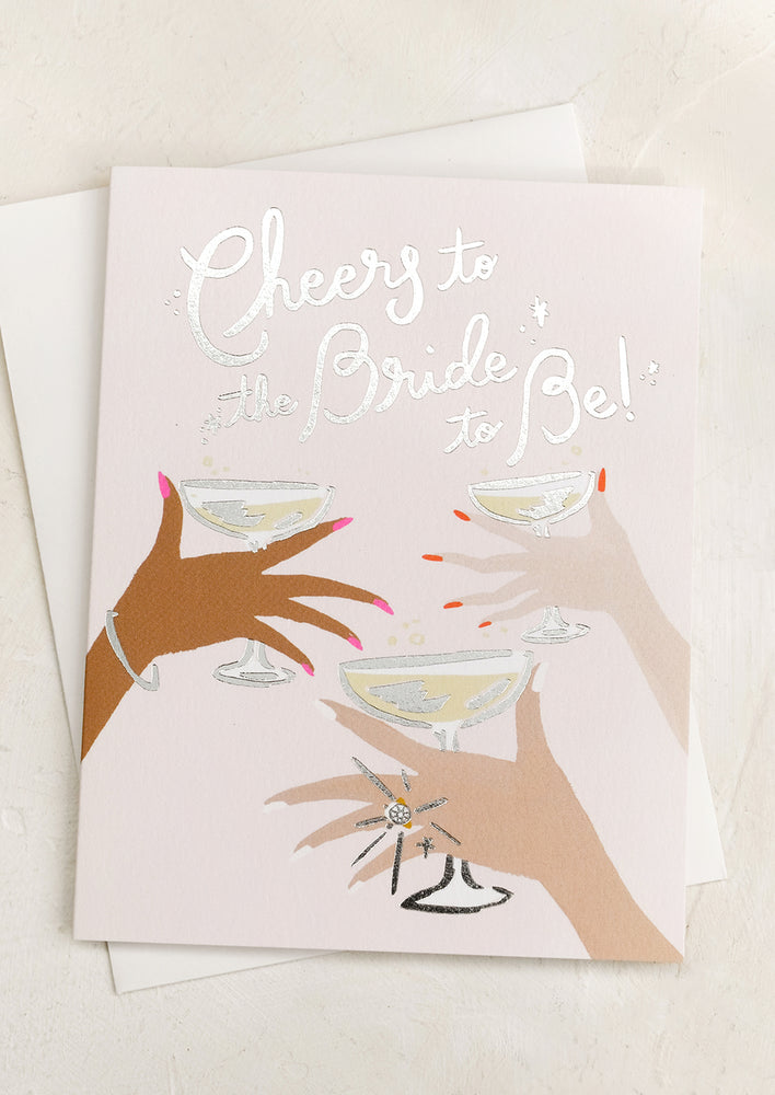 1: A greeting card reading "Cheers to the bride to be!".