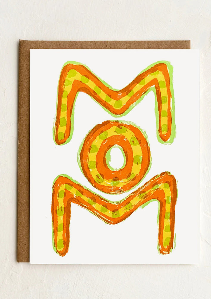 A card reading "MOM" in neon orange, yellow and green lettering.