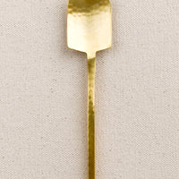 Spoon: A small canape spoon in hammered gold finish.