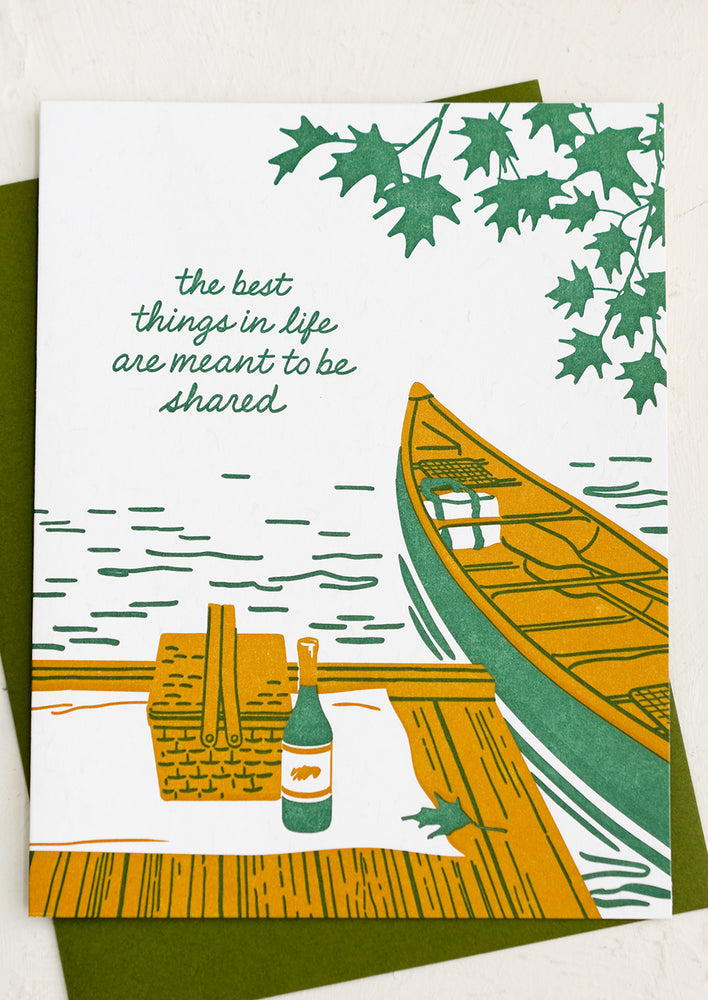 A card with image of canoe on lake, text reads "The best things in life are meant to be shared".