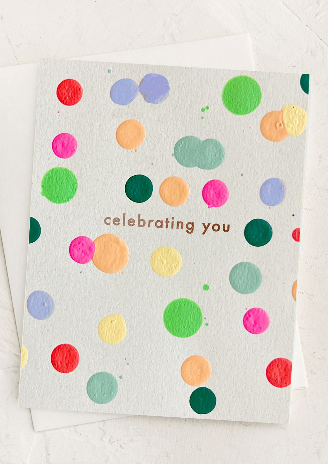 A card with colorful dots reading "Celebrating you".