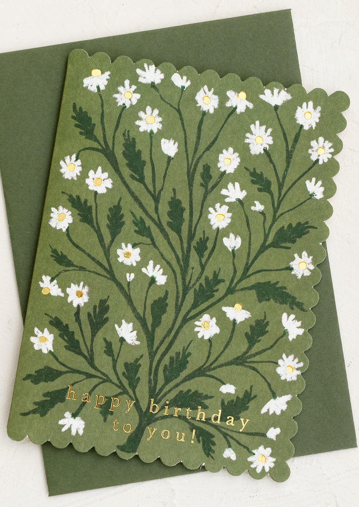1: A scalloped edge birthday card with chamomile floral print on olive green.