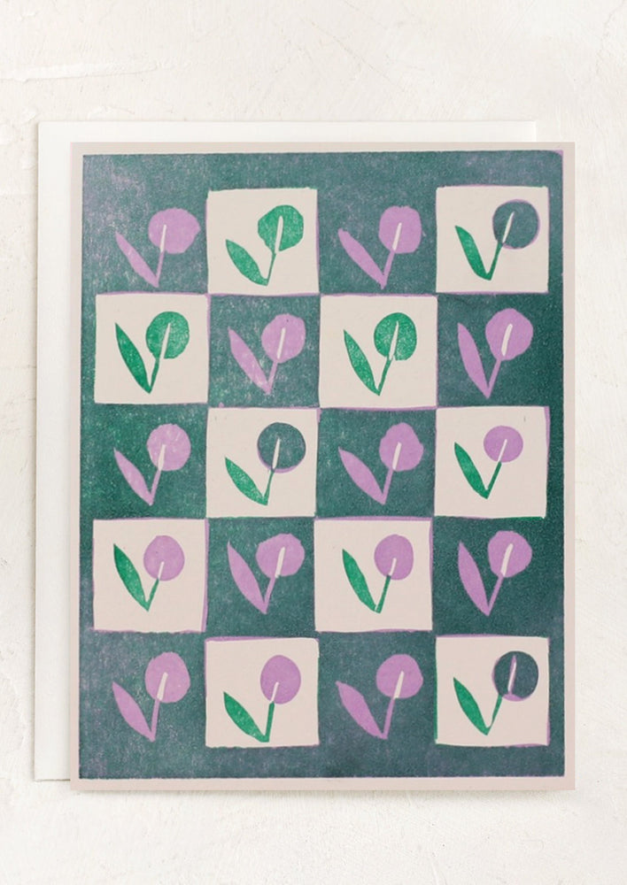 A checkered floral print greeting card in teal, green and lavender tones.