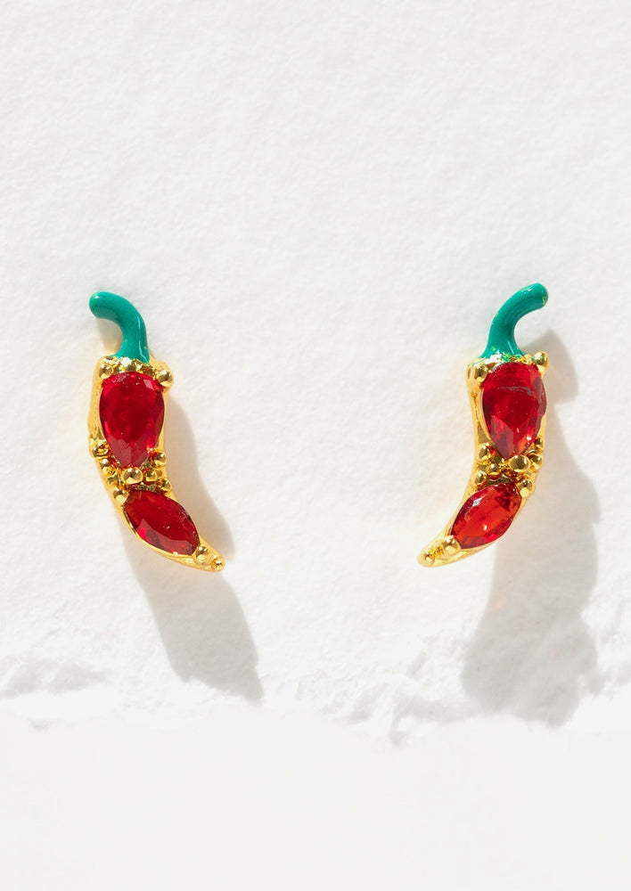 1: Gold stud earrings in the shape of red chili peppers.