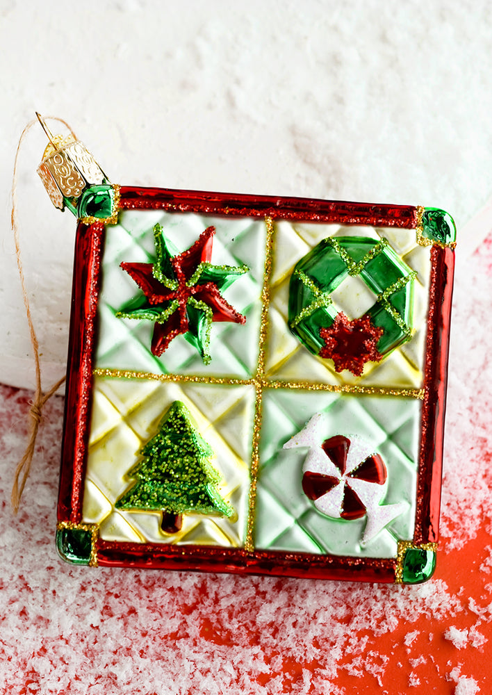 1: A glass Christmas quilt ornament.