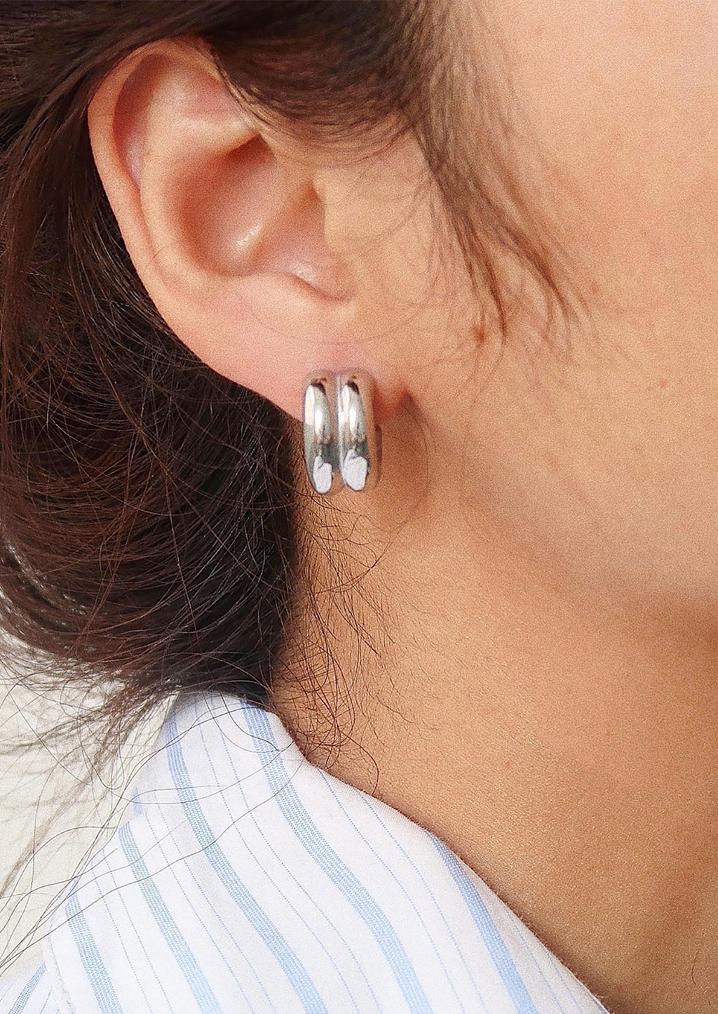 Silver: A pair of chunky rib textured hoop earrings in silver.