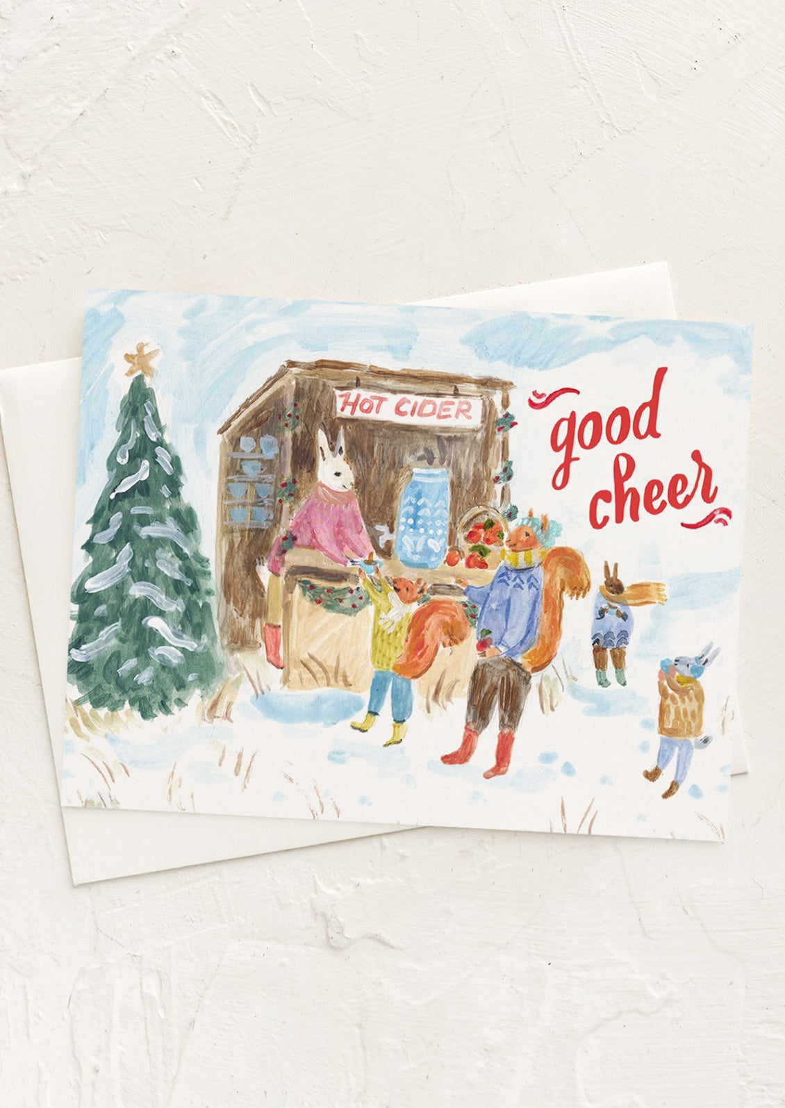 A card with illustration of animals waiting in line for hot cider, text reads "Good Cheer".