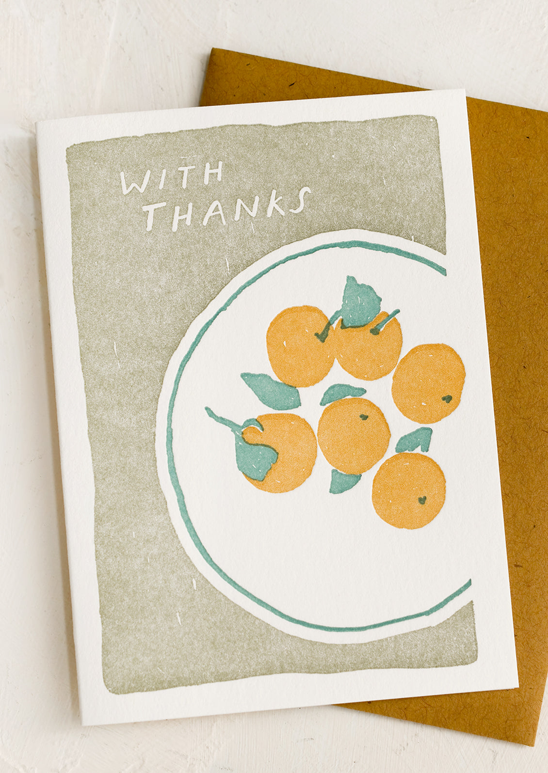 A thank you card with letterpressed image of oranges on a plate.