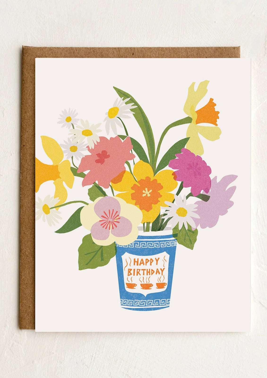 Greeting card with a bouquet of flowers in a coffee cup and 'Happy Birthday' text on a white background