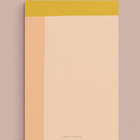 Peach Multi: A colorblock notepad in peach and yellow.