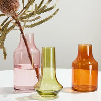 1: Three transparent glass vases in assorted colors and shapes.