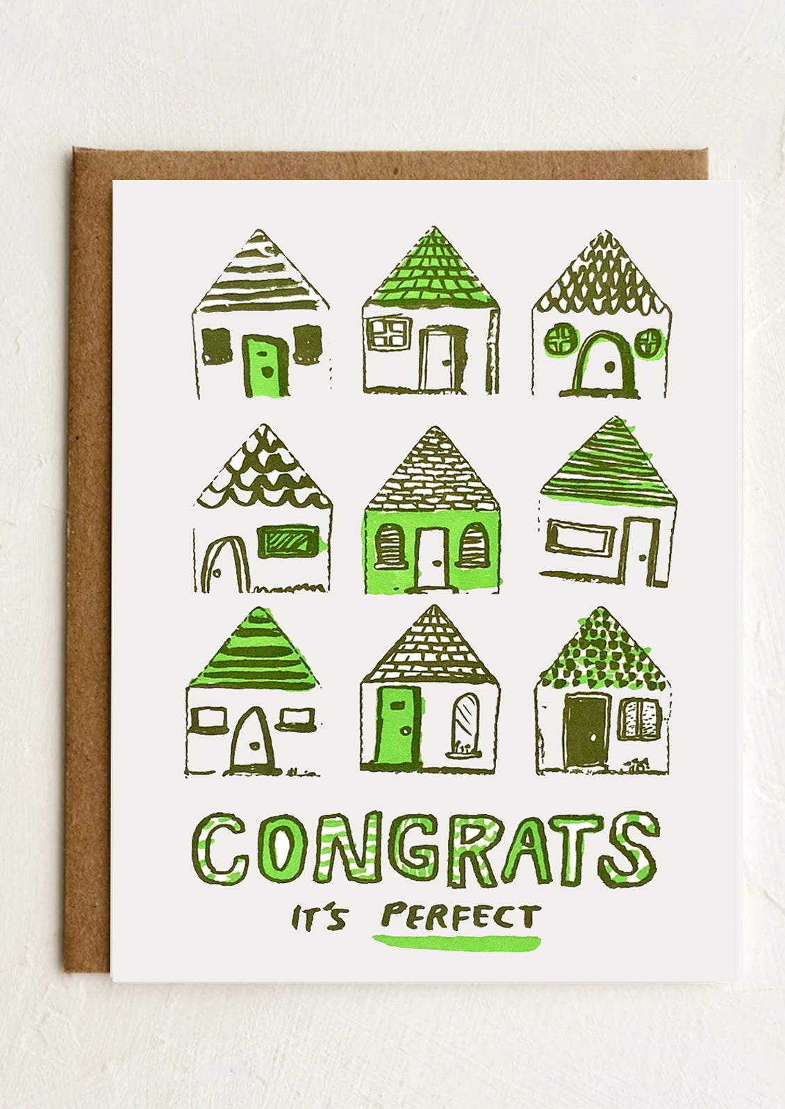 A greeting card with imagery of houses, text reads "Congrat's It's Perfect".